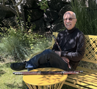 David Bilides photo on yellow bench holding kavals